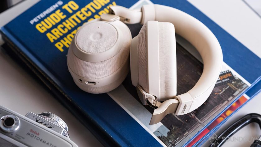 The Jabra Elite 85h noise cancelling headphones folded on a stack of books.