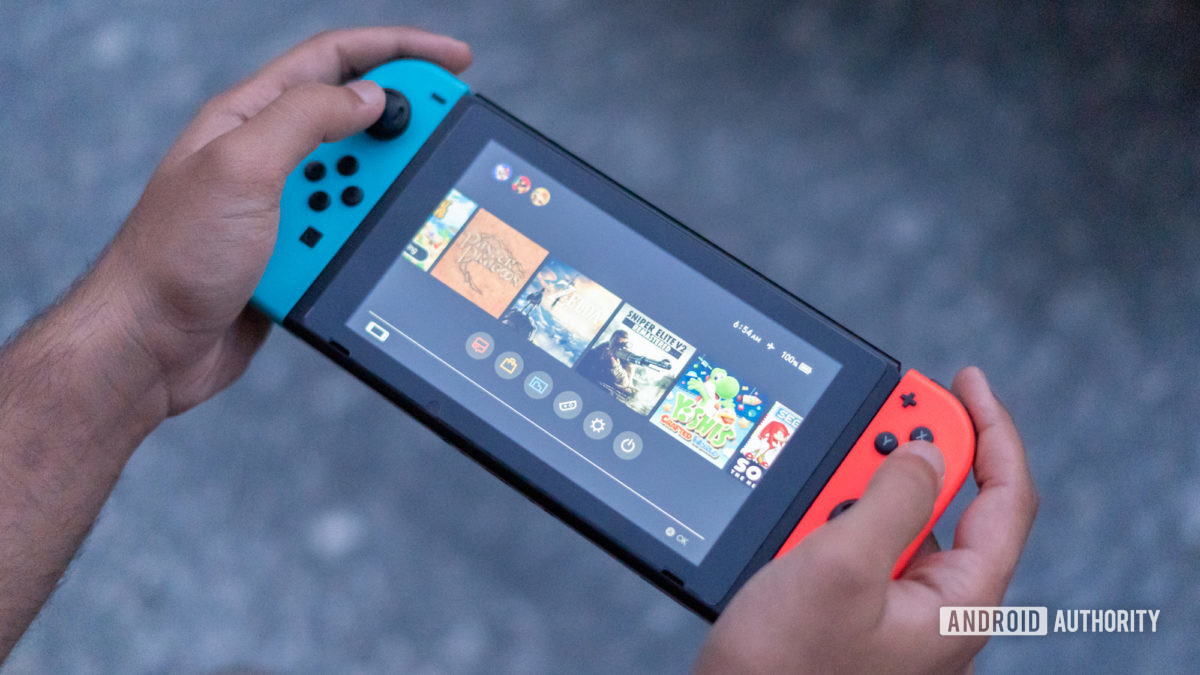 Hands holding a Nintendo Switch console.