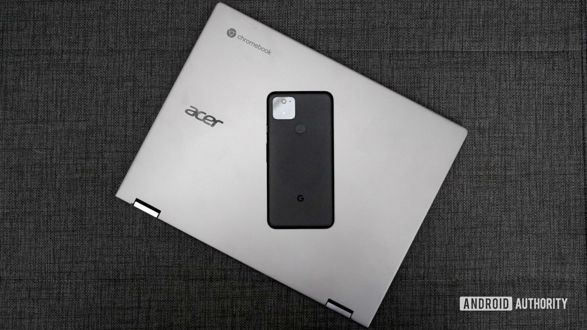 The Acer Chromebook Spin 713 with a phone on top of the laptop.