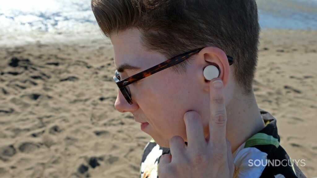 Close up on a man with the Google Pixel Buds A-Series using touch controls.