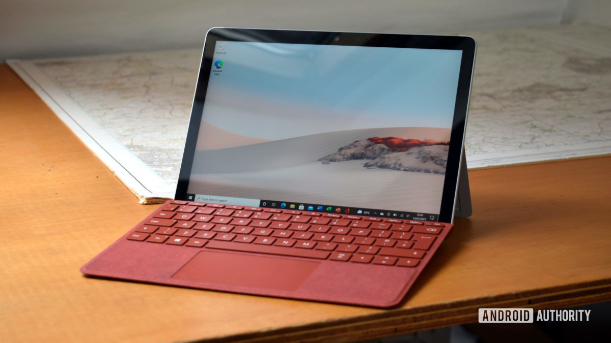 The Microsoft Surface Go 2 review with a Poppy Red Surface Go Type Cover sitting on a desk.