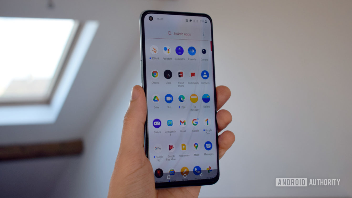 OnePlus Nord 2 in hand showing the screen and apps.