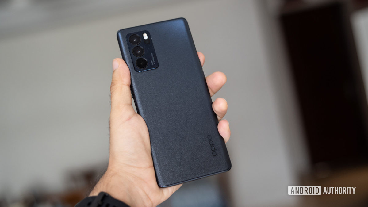 The Oppo Reno 6 Pro in hand showing the back and camera module.