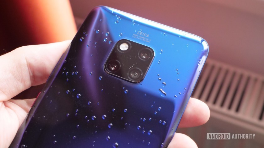 The Huawei mate 20 Pro in Twilight in hand with water on the back