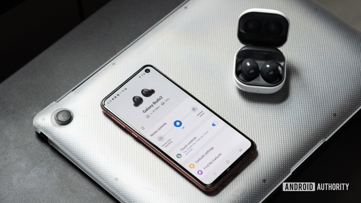 The Samsung Galaxy Buds 2 noise cancelling true wireless earbuds in the open charging case while connected to the Galaxy Wearable app on a Samsung Galaxy S10e.