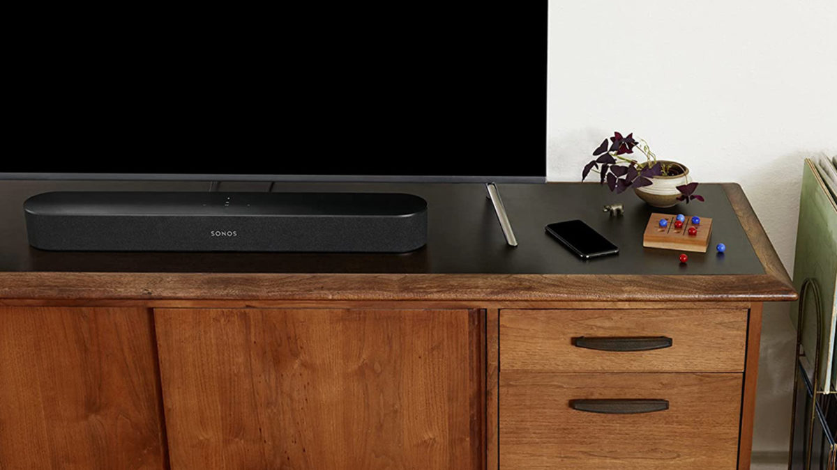 A picture of the Sonos Beam soundbar in black on a TV stand.