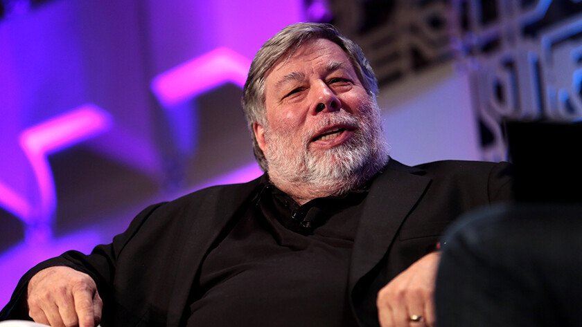 Apple co-founder Steve Wozniak sitting in a chair during an on-stage interview.