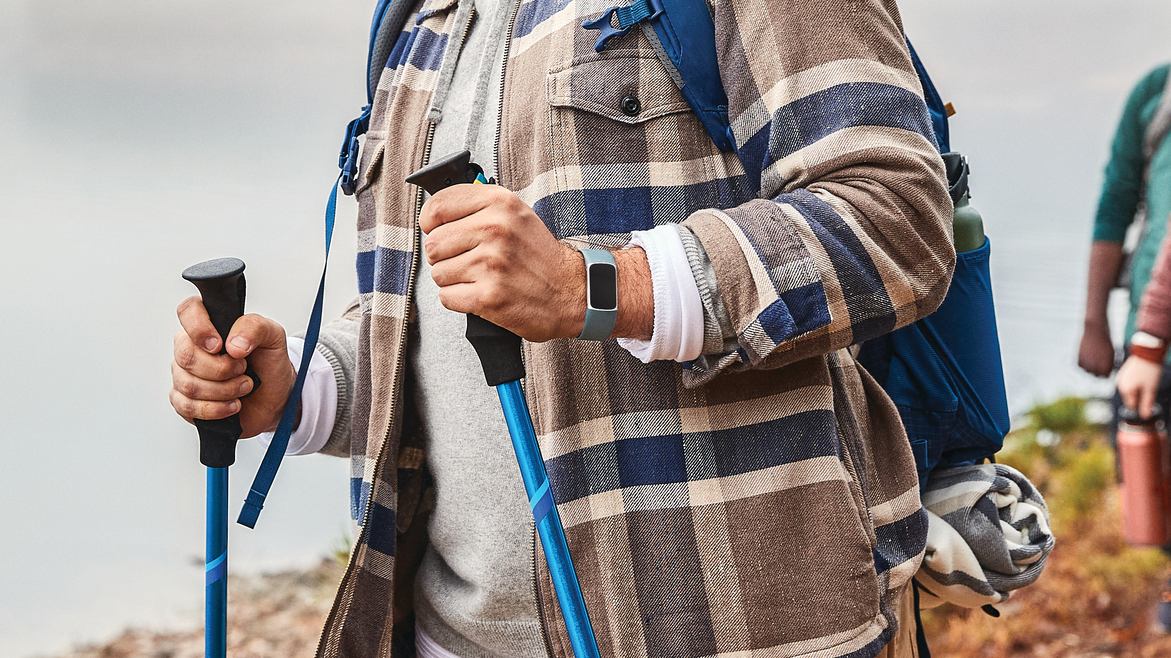 fitbit charge 5 steel blue platinum on mans wrist