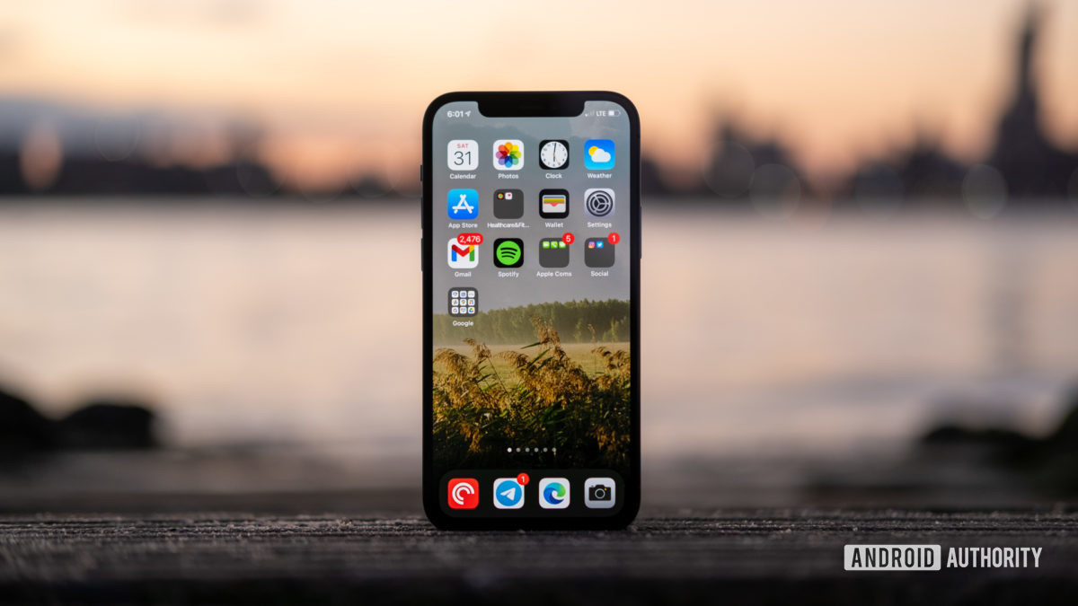 iPhone 12 Pro display standing up agaist sunset