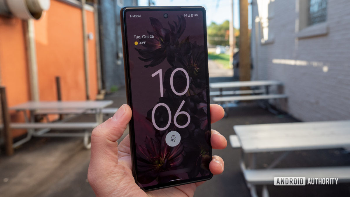 The Google Pixel 6 in Sorta Seafoam color in hand showing the lock screen and display