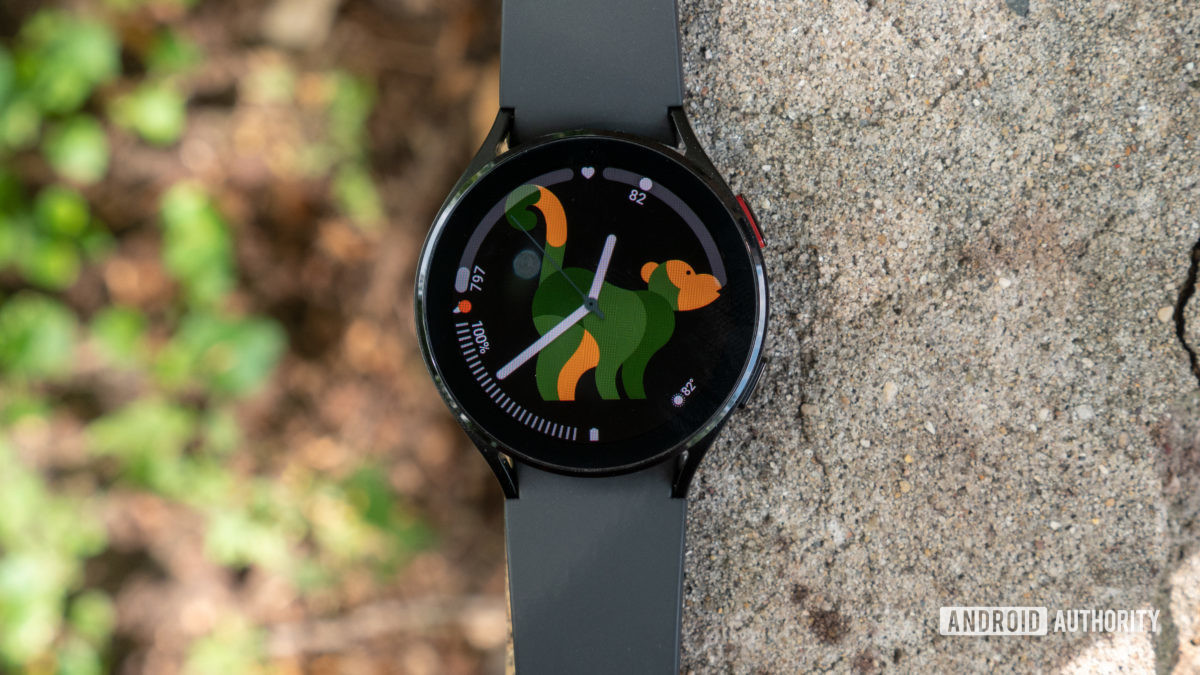 The Samsung Galaxy Watch 4 lying flat on a brick.