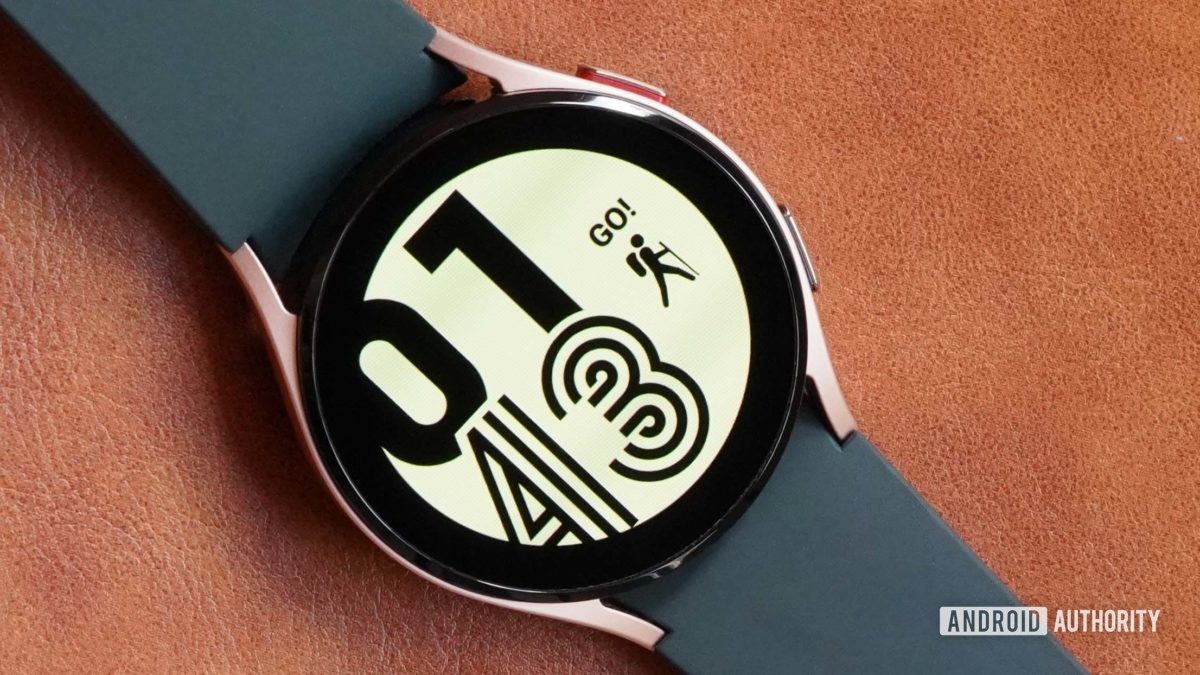 A Samsung Galaxy Watch 4 on a leather surface displays the watch face Active.