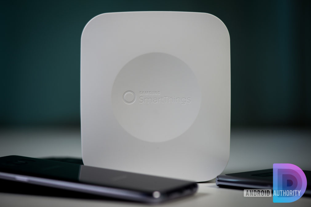 Samsung SmartThings hub next to smartphones