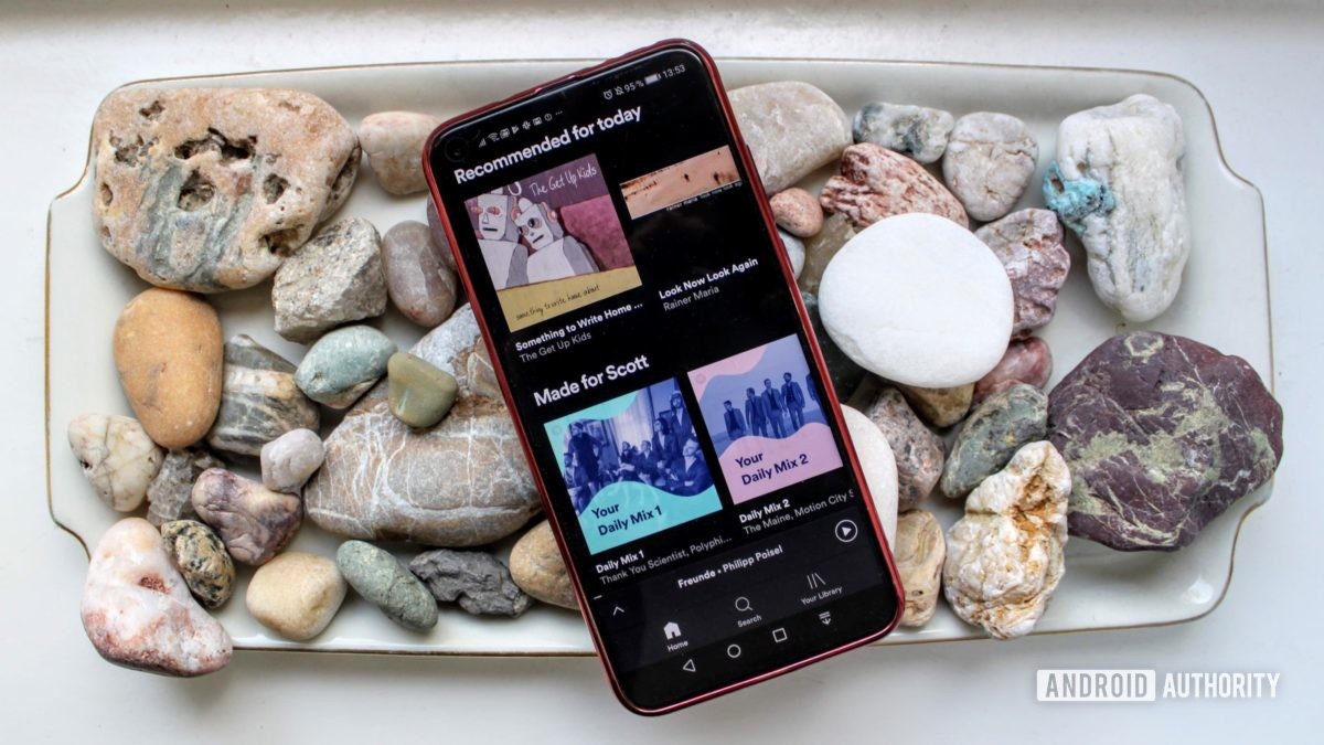 Spotify menu on a smartphone on a bed of rocks