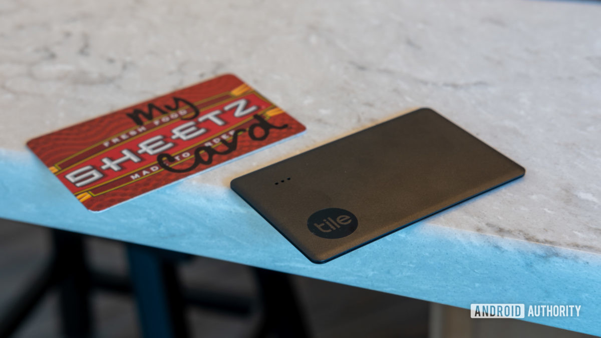 The Tile Slim (2022) alongside a rewards card.