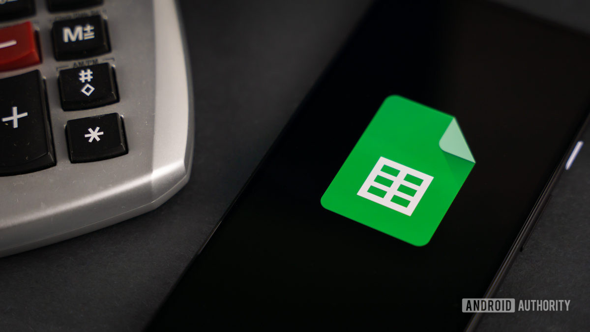 Google Sheets next to calculator stock photo 1