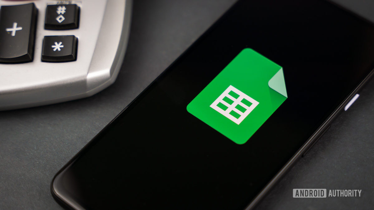 Google Sheets next to calculator stock photo 2