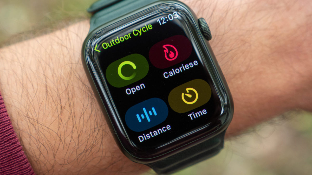 An image of the Apple Watch Series 7 on a wrist showing the outdoor cycling settings screen