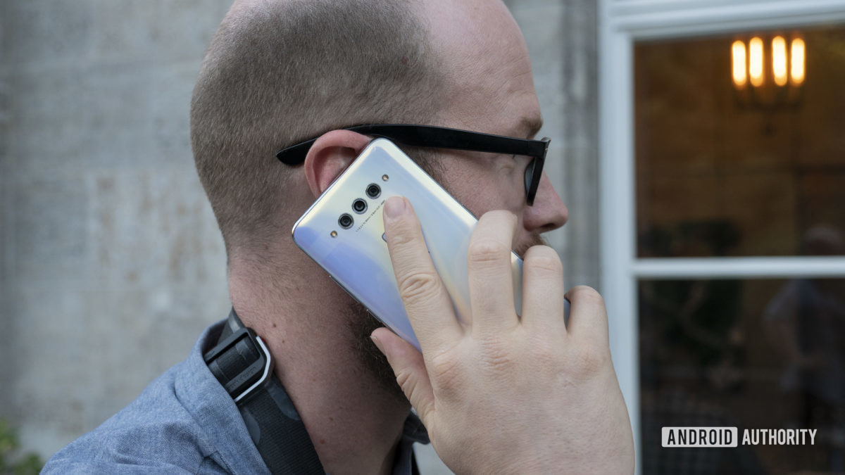 TCL Plex hands on white in hand phone call up to ear