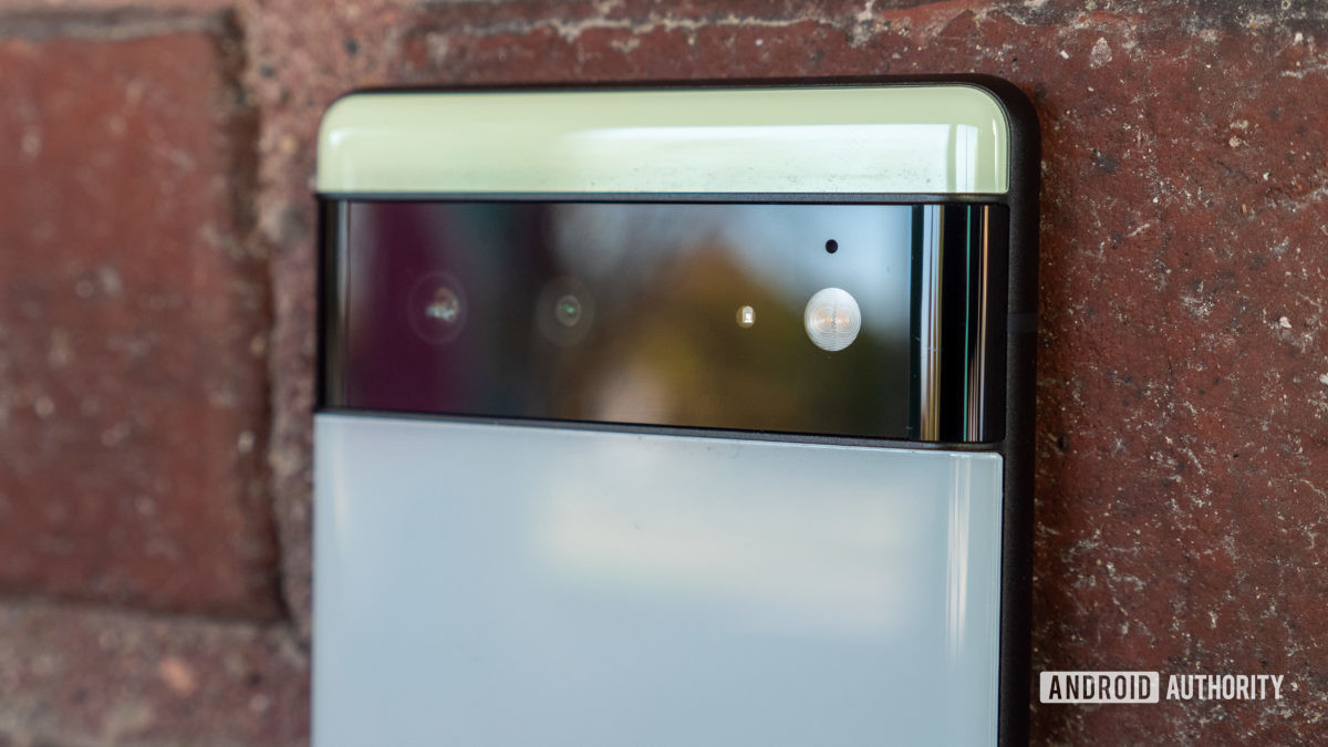 The Google Pixel 6 in Sorta Seafoam color camera bar up close against brick