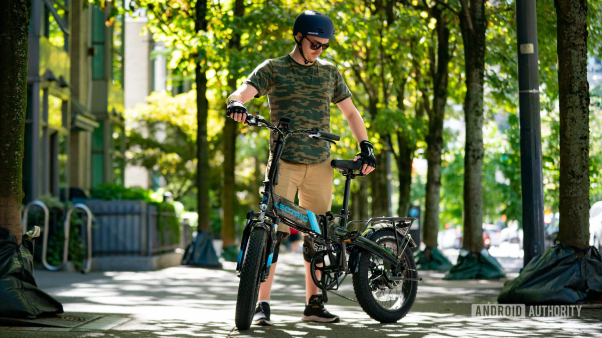 Lectric XP 2.0 1 Adam standing with XP 2.0 electric bike under trees