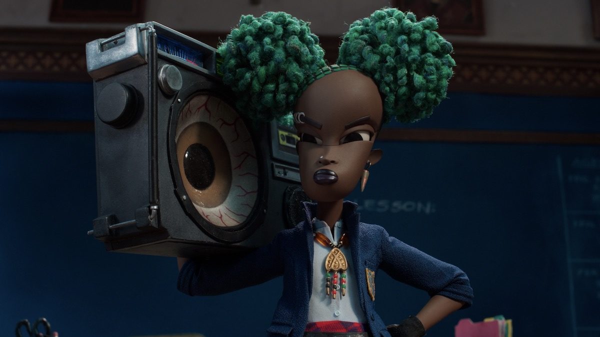 A girl with green hair holds a boombox on her shoulder in Wendell and Wild