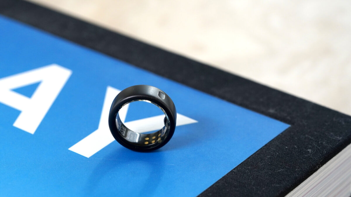 An Oura Ring 3 rests on a coffee table book.