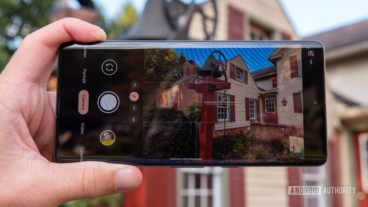 google pixel 7 pro camera app in hand taking a shot of the exterior of a house