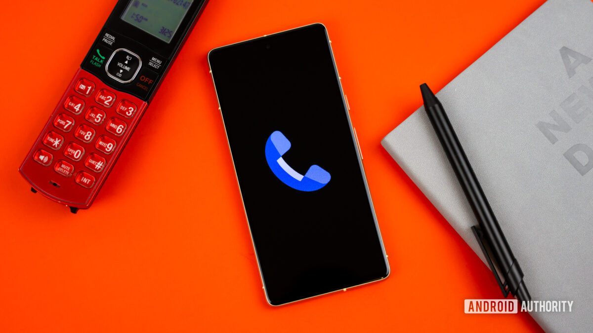 Stock photo of Phone by Google app on phone next to home phone agenda and pen 1