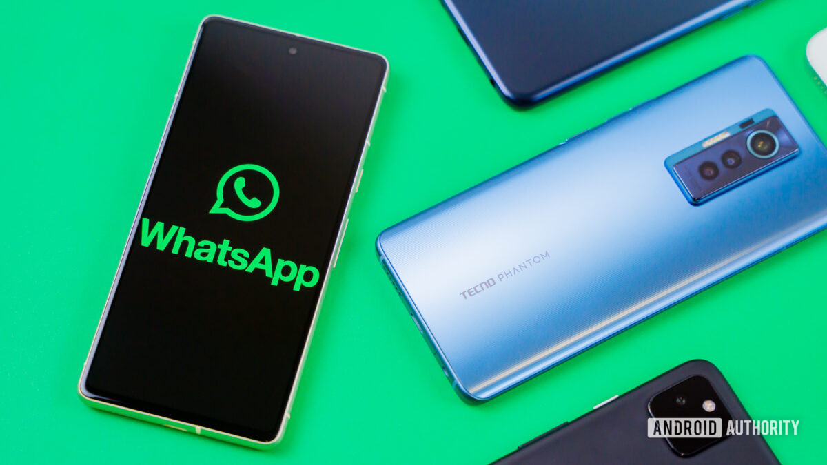 WhatsApp logo on smartphone next to other devices Stock photo 4