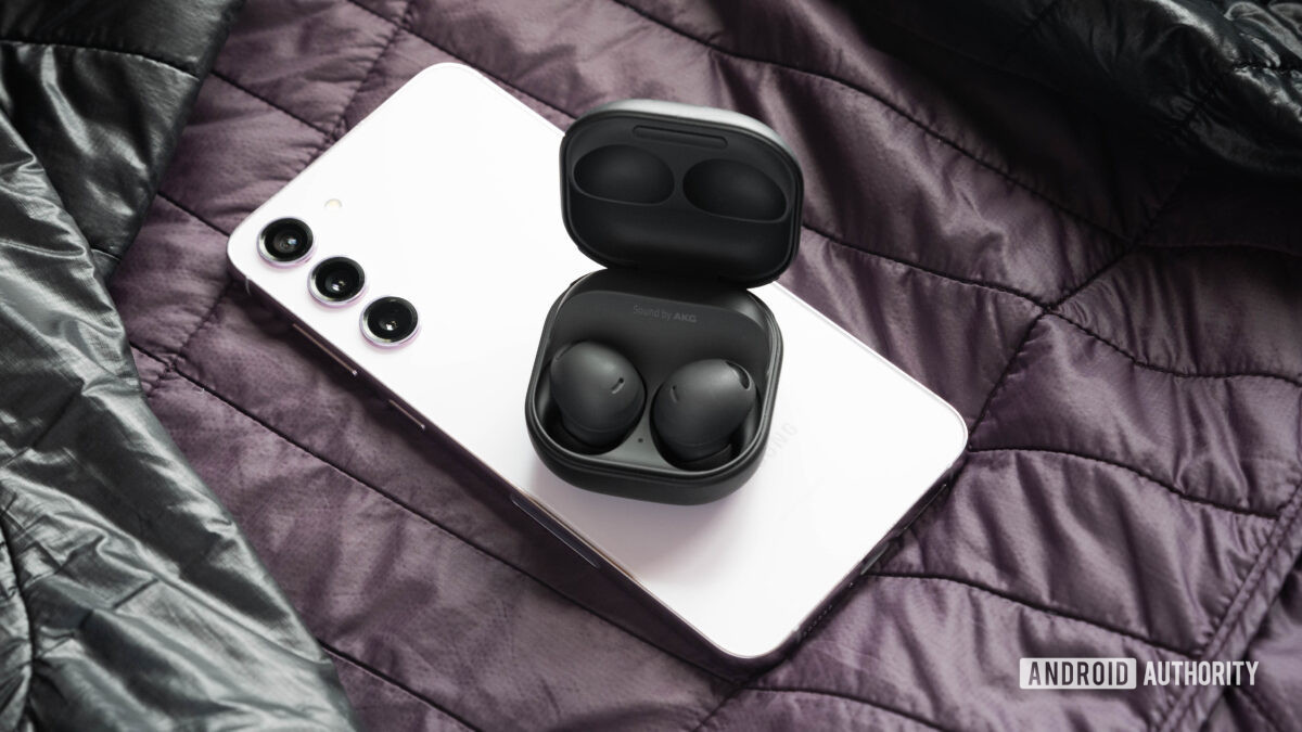 The samsung galaxy buds 2 pro earbuds and case on top of a Galaxy S23 Plus.