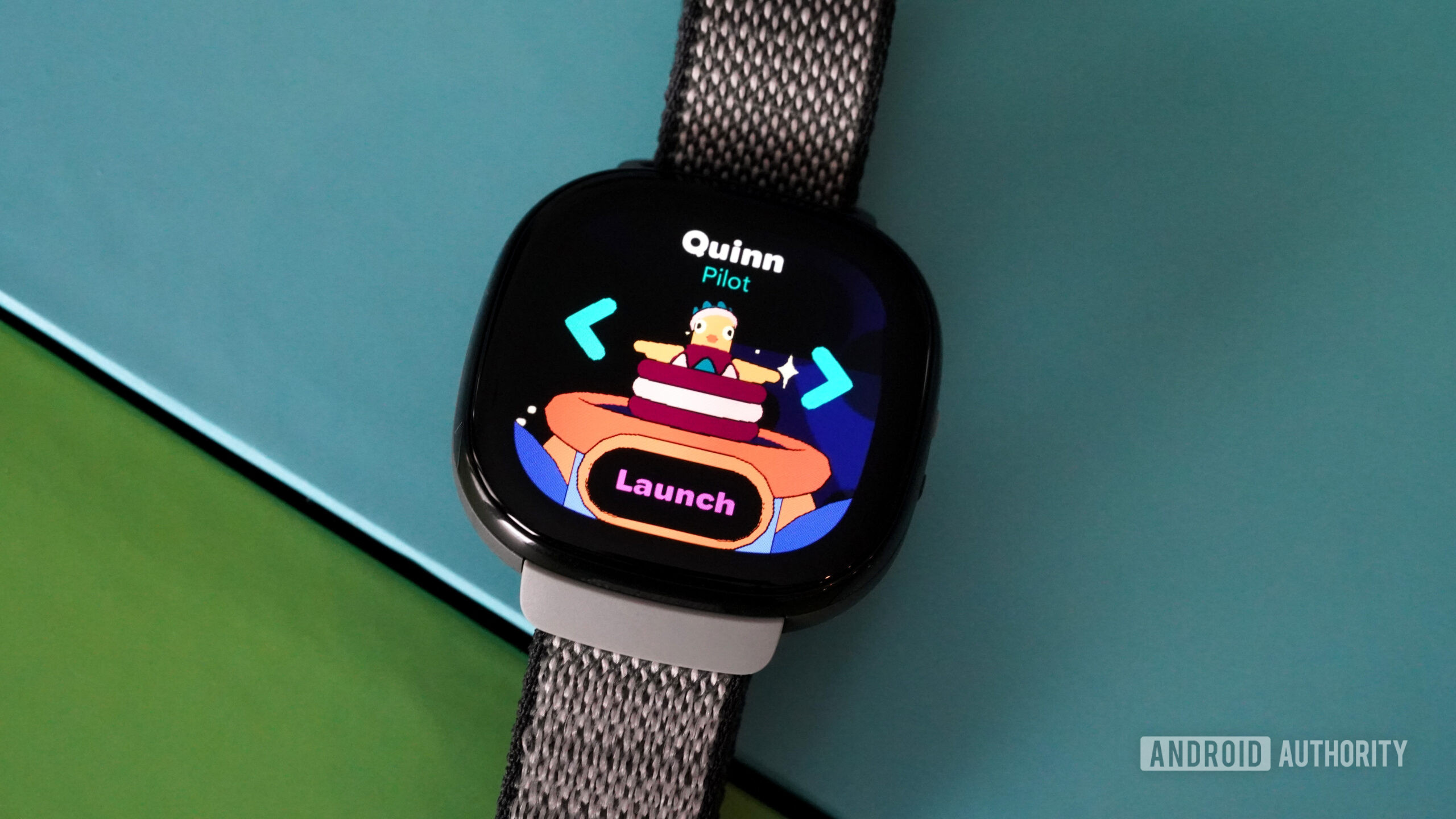 A Fitbit Ace LTE displays the launch screen of Pollo 13 Fitbit Arcade game.