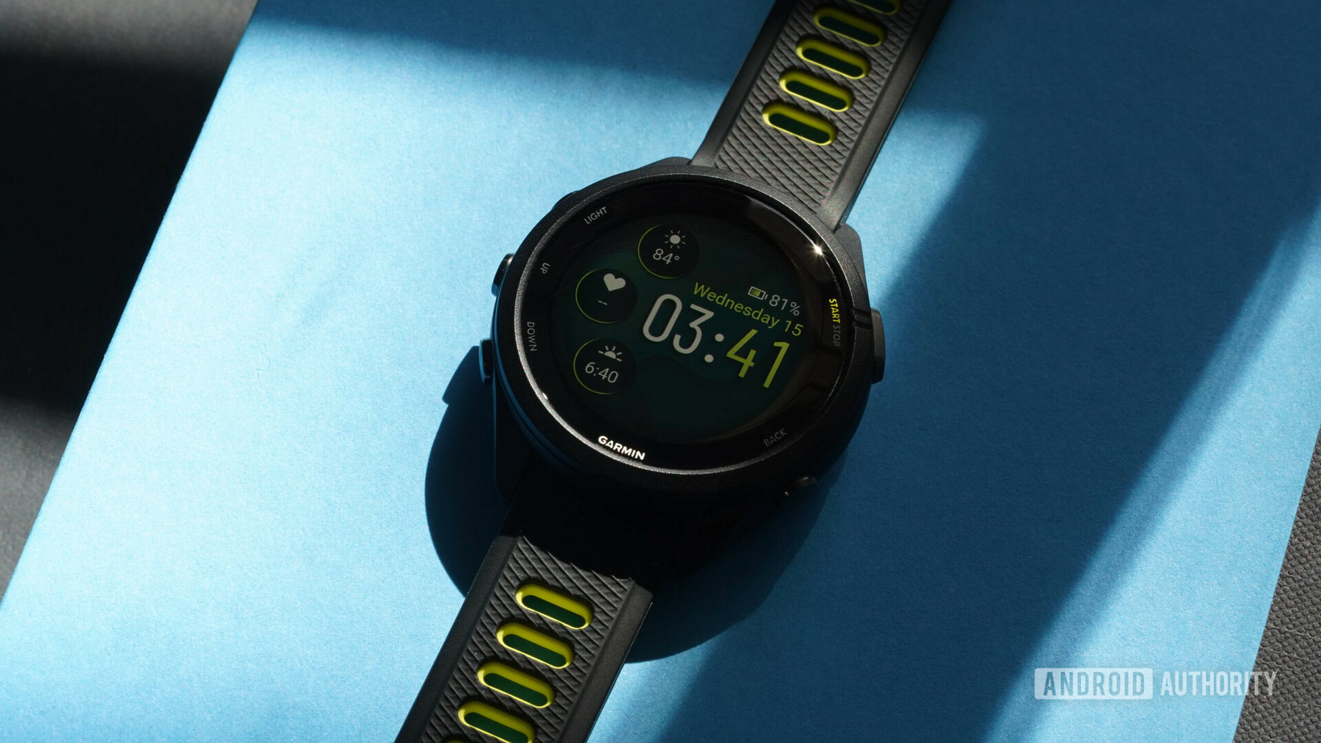 A Garmin Forerunner 265S displays a native watch face.