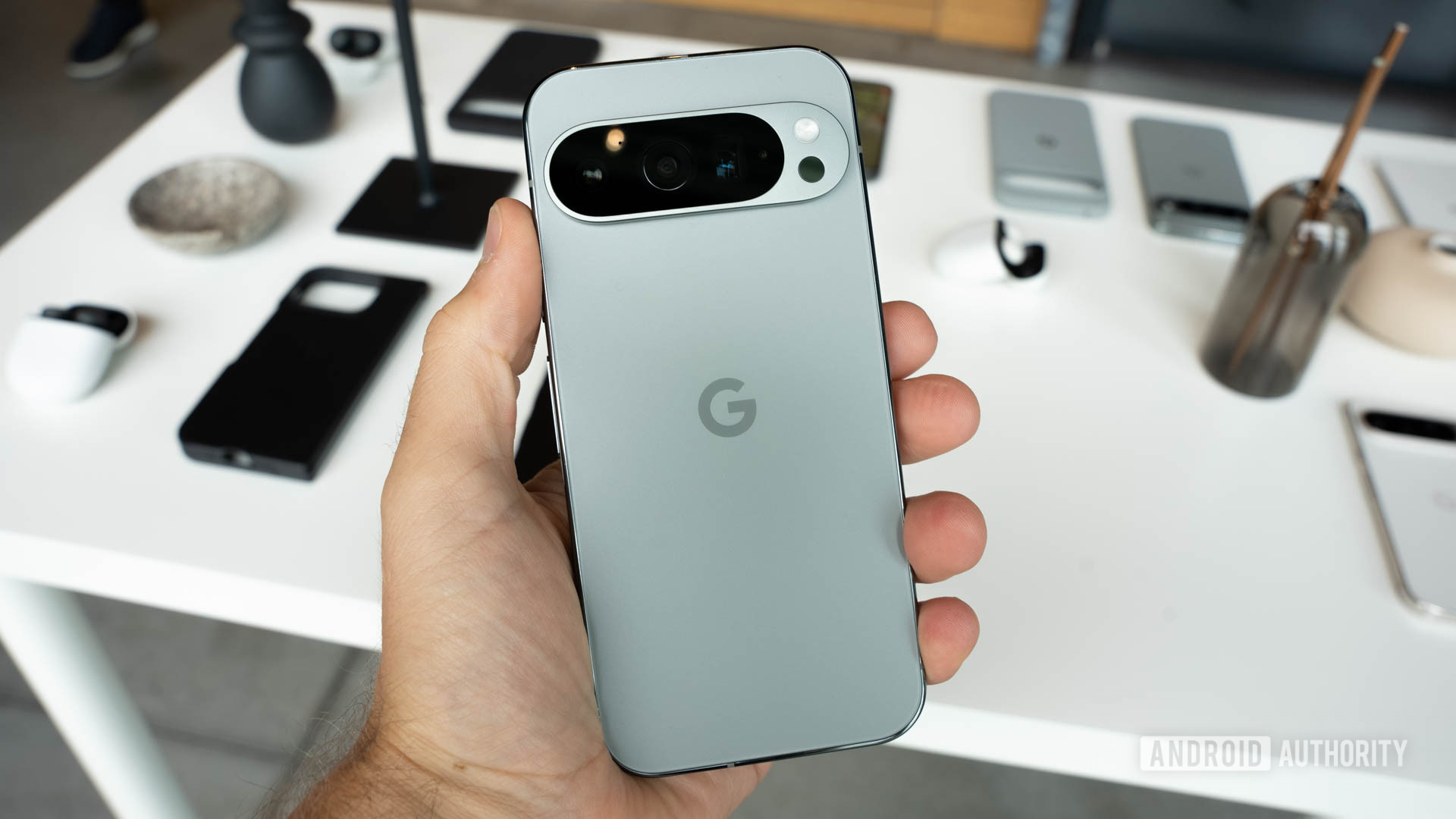 Google Pixel 9 Pro in Hazel color held in person's left hand with back facing viewer