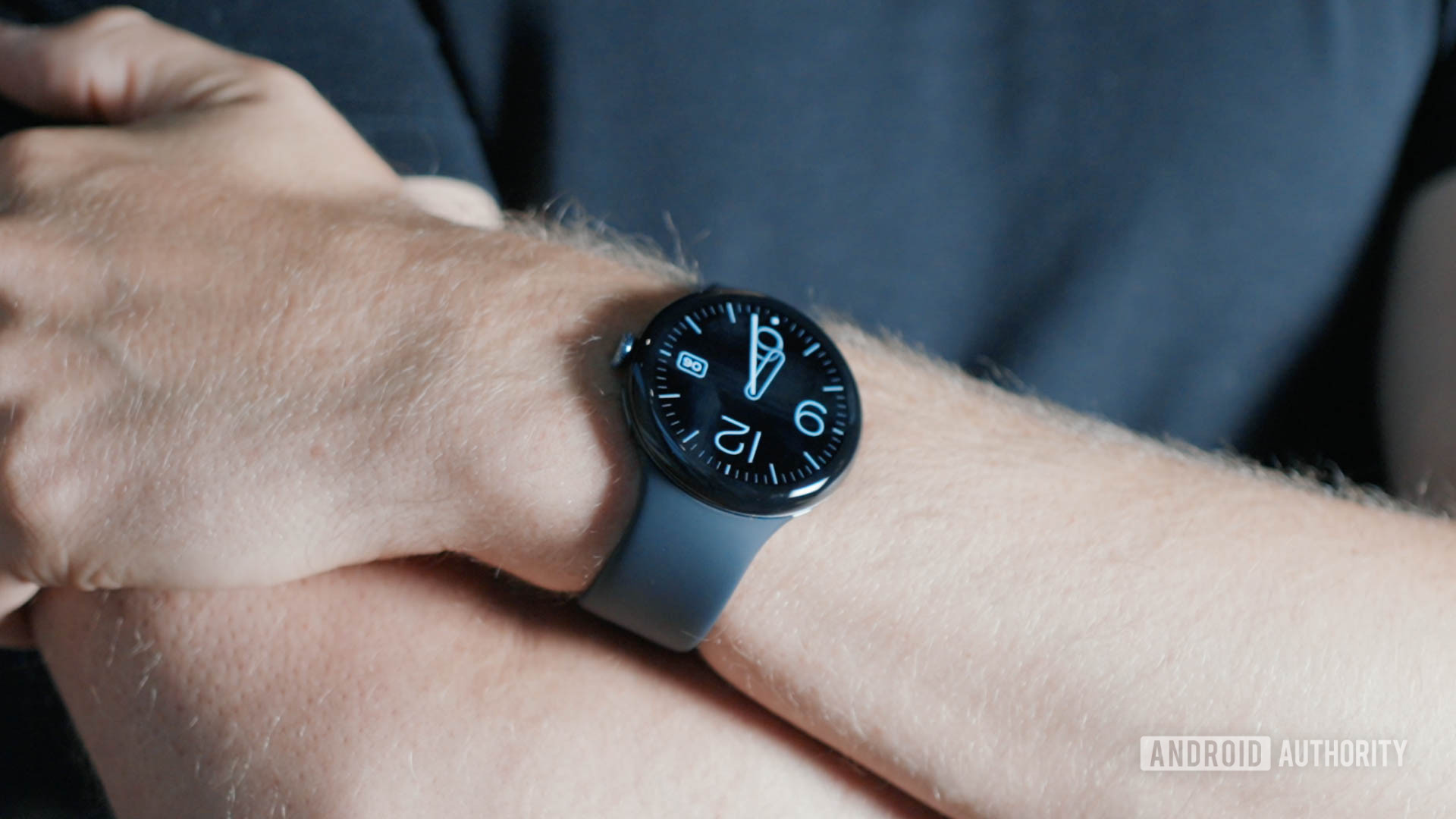 A Pixel Watch 3 on a user's wrist display the time.