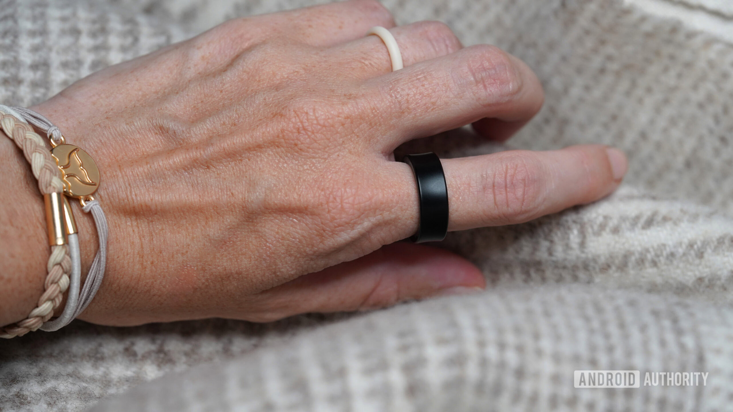 A Samsung Galaxy Ring user reaches for a blanket.