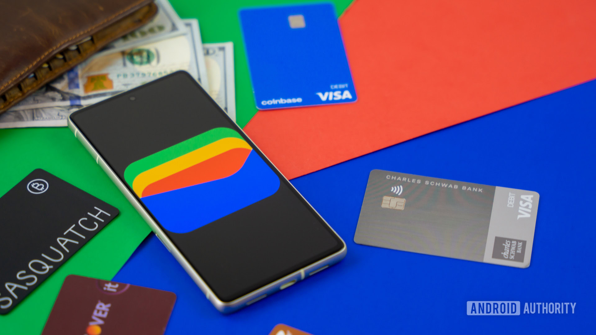 Google Wallet logo on smartphone next to credit cards and cash Stock photo 1