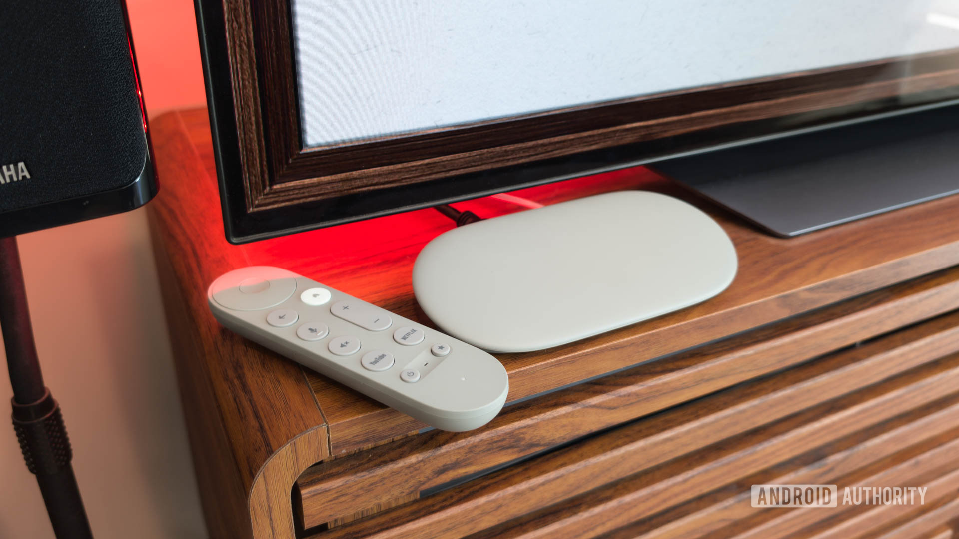 Google TV Streamer with Remote on TV console with red light