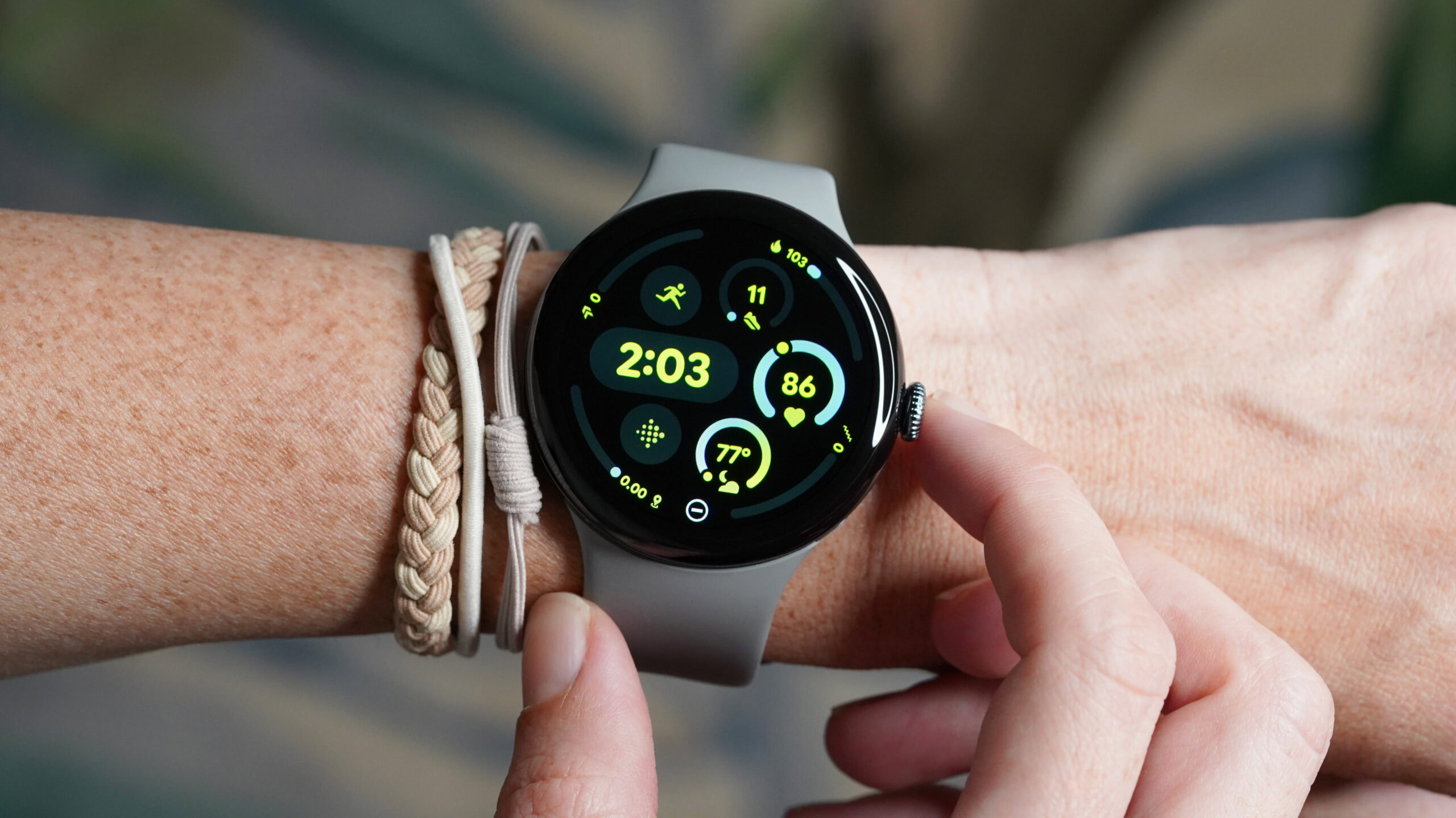 A 45mm Google Pixel Watch 3 on a user's wrist displays the watch face.