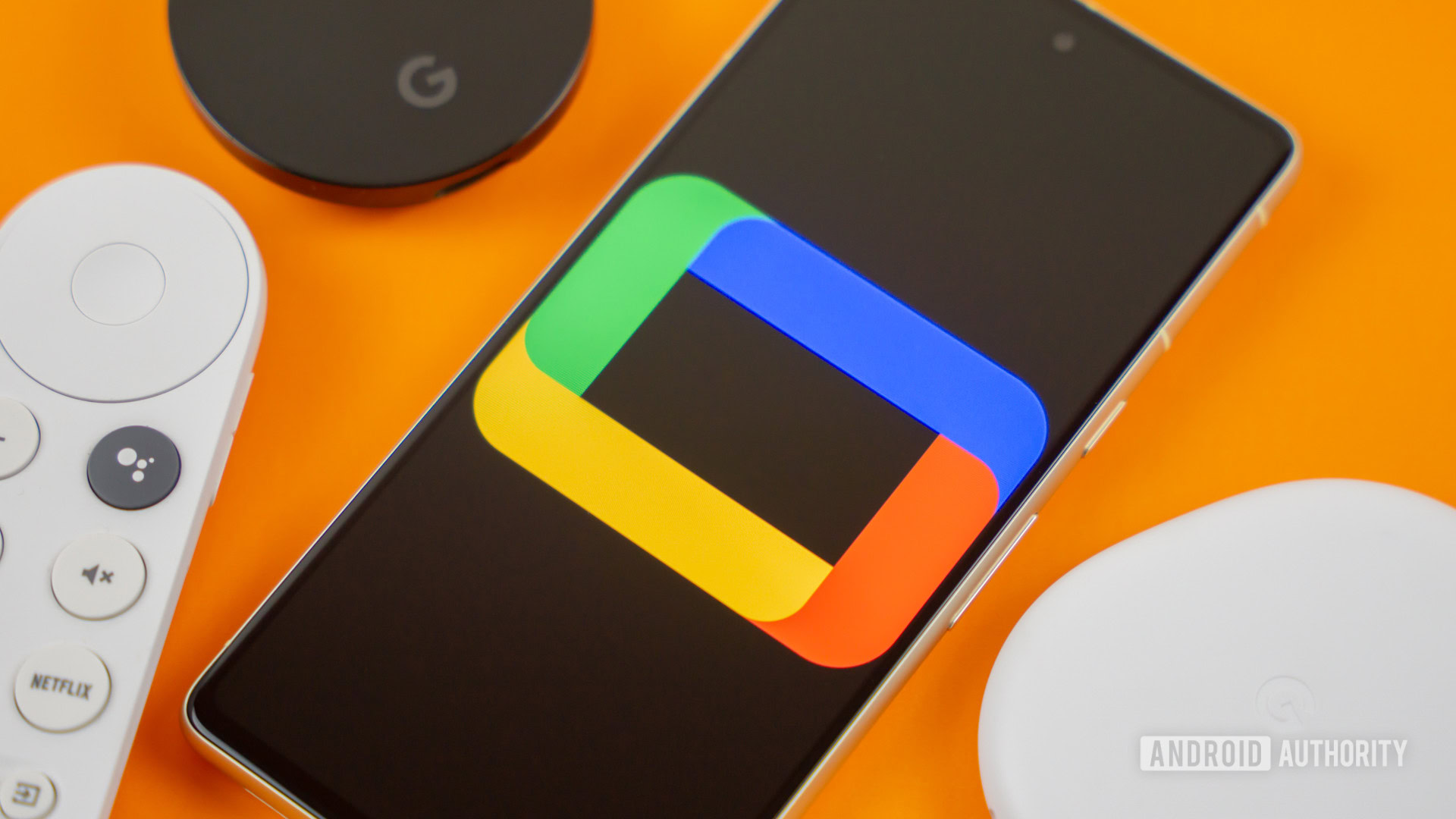 Google TV logo on smartphone next to Chromecast devices and remote Stock photo 1