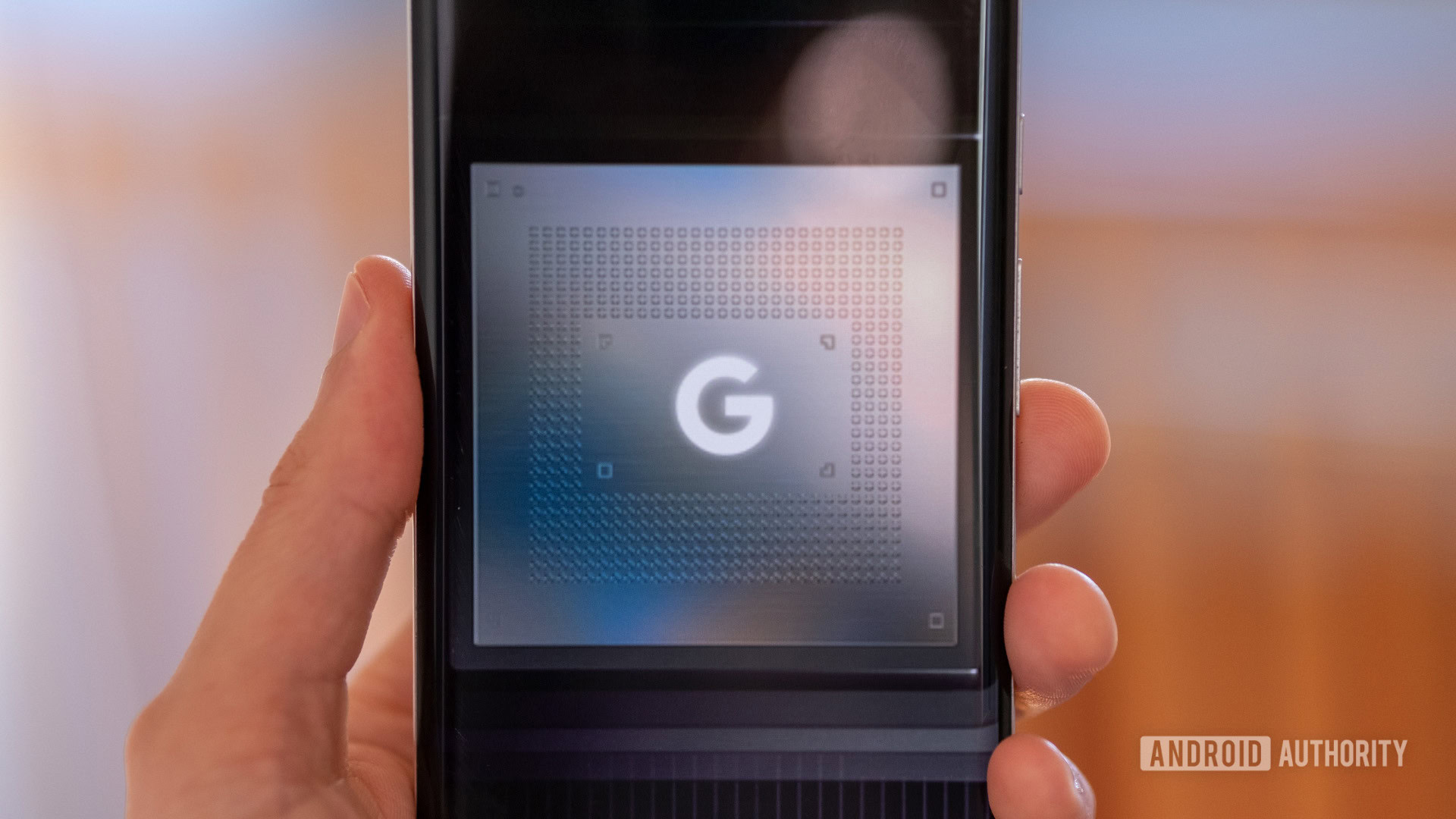 Google Tensor chip logo phone in hand Google Tensor chip logo phone in hand