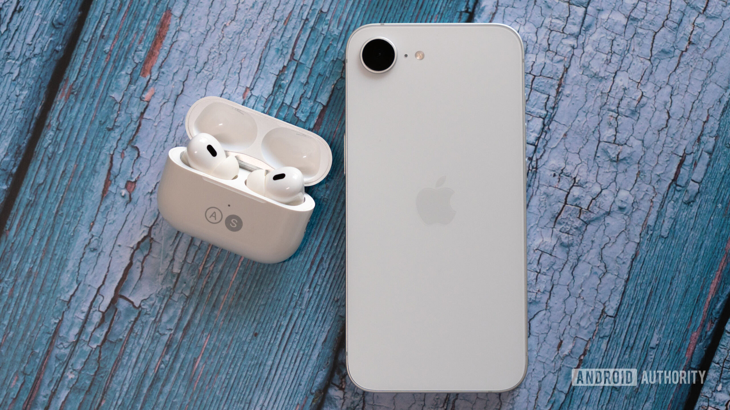 Apple iPhone 16e besides AirPods Pro 2