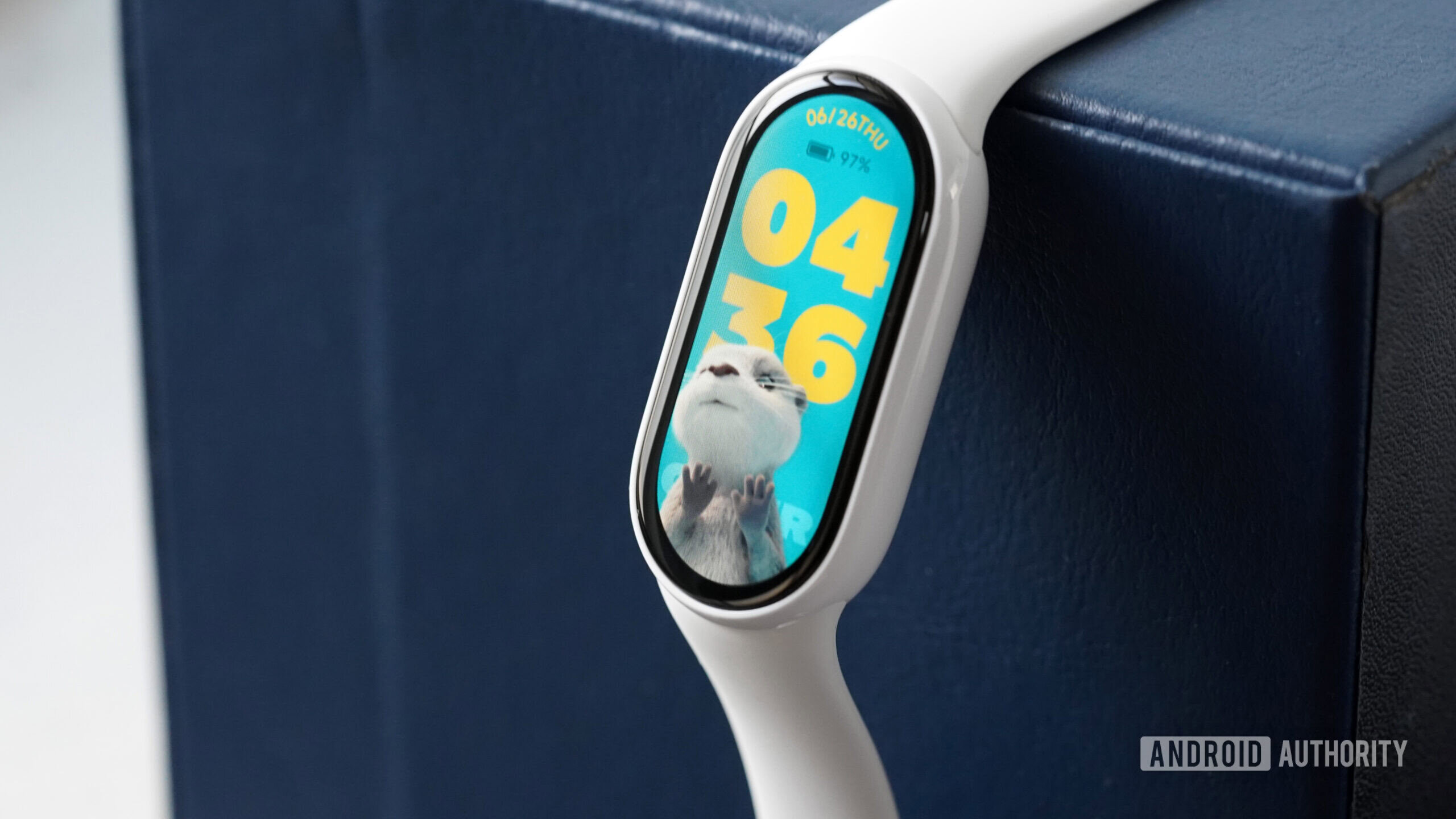 A Xiaomi Smart Band 10 displays an adorable otter watch face.