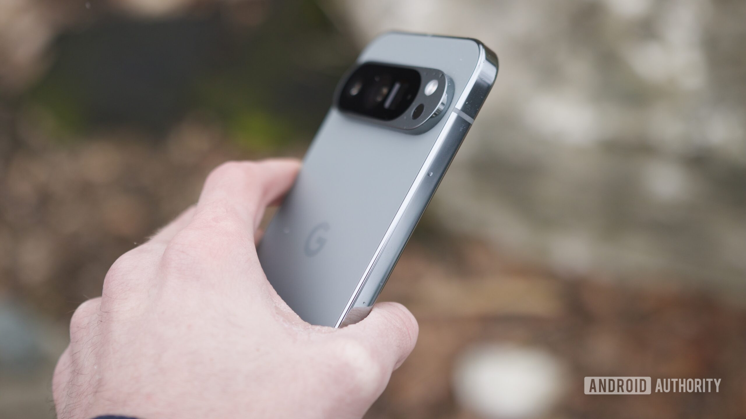google pixel 9 pro revisit 7 Someone holding the Google Pixel 9 Pro outside.