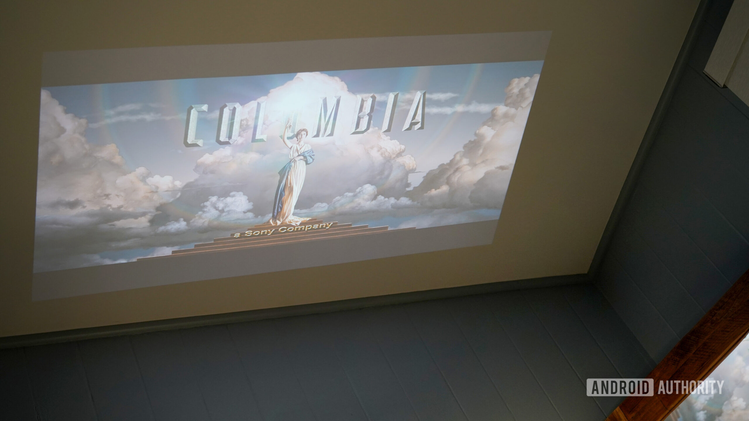 A Dangbei N2 Mini Projector screens a film on a user's ceiling.