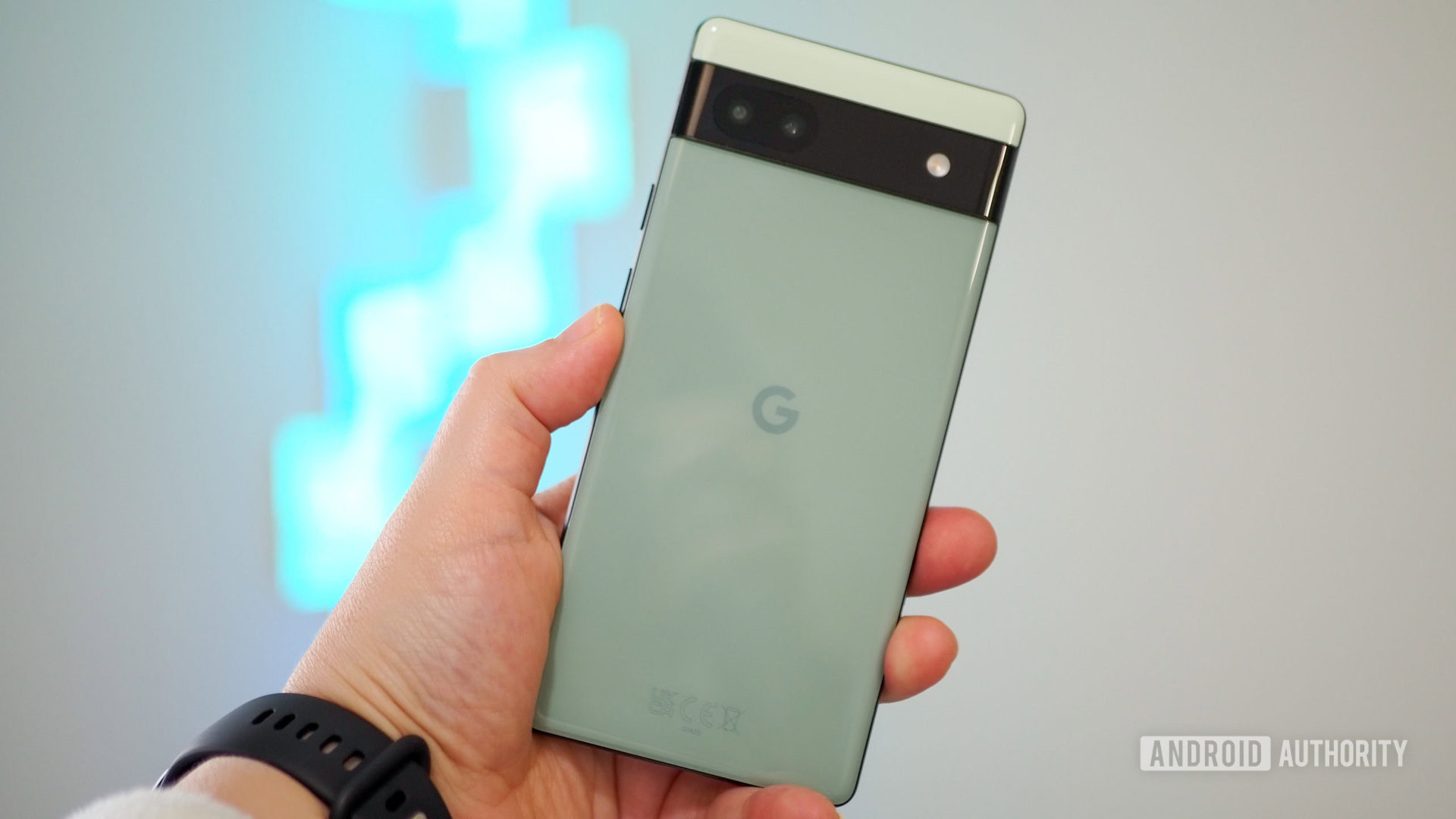 google pixel 6a in hand 2 Google Pixel 6a in Sage color in hand, seen from the back