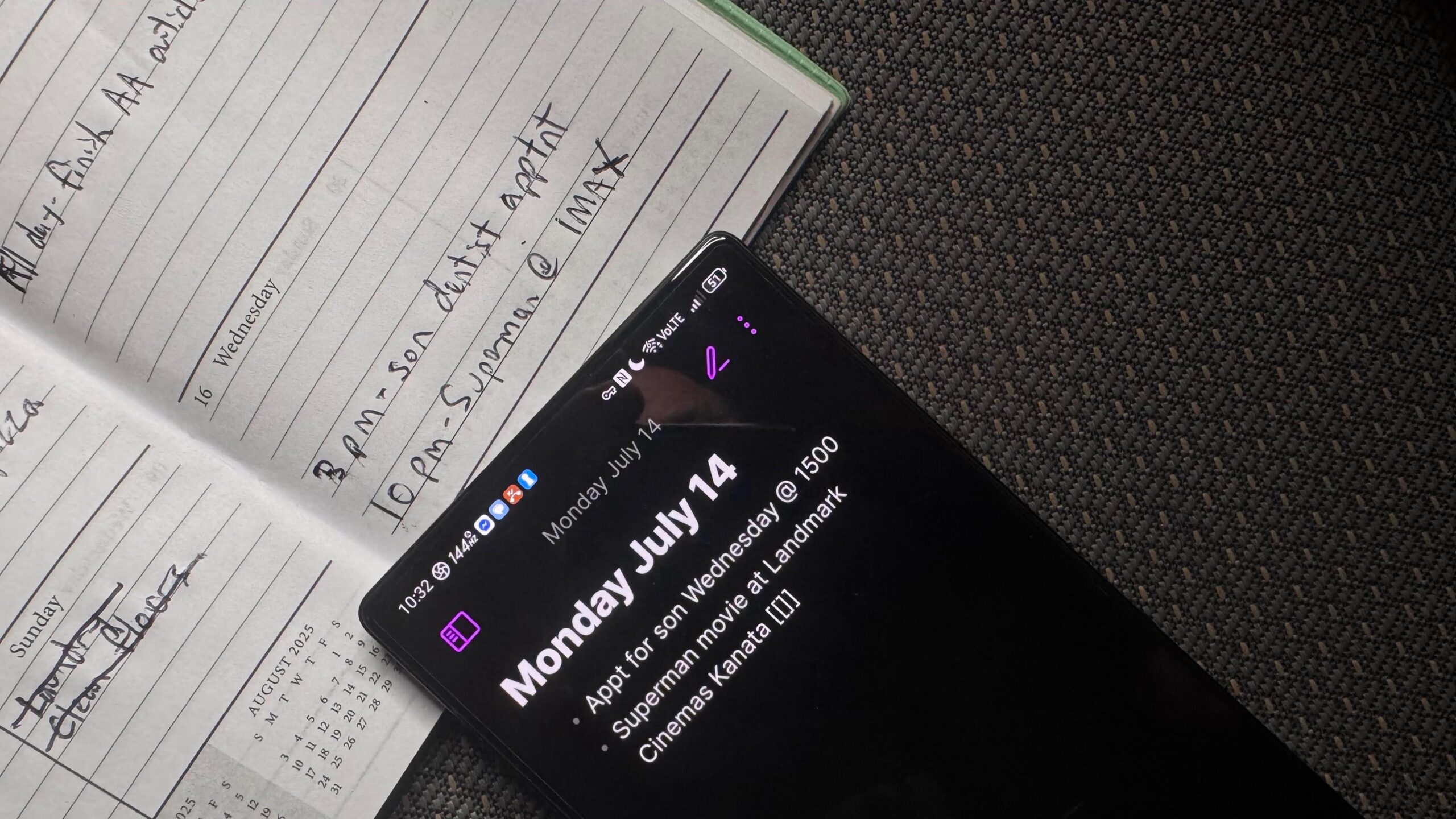 The Obsidian app open on a black Android with a white paper planner underneath.