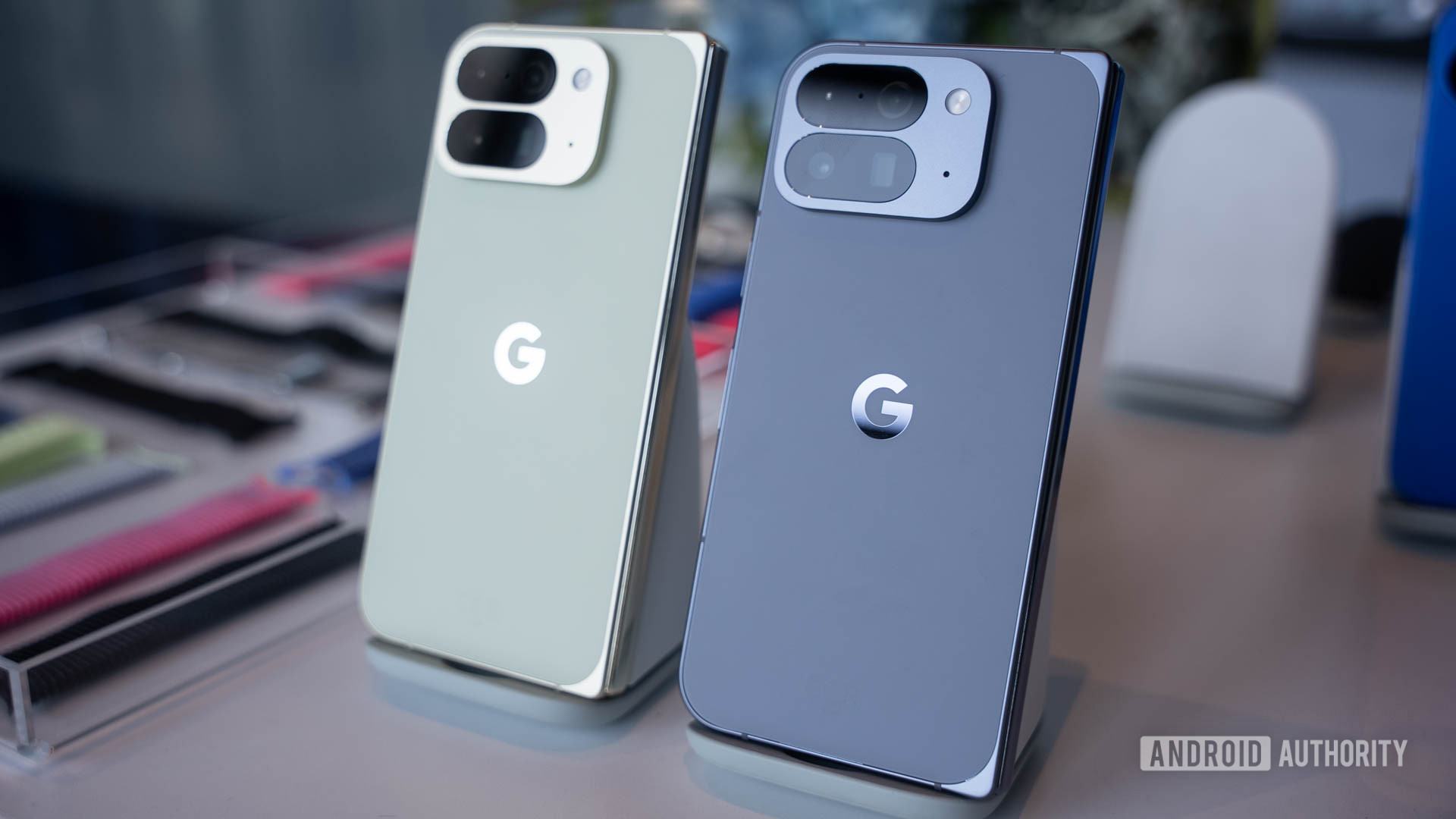 Google Pixel 10 Pro Fold in Jade next to Google Pixel 10 Pro Fold in Moonstone on stands Google Pixel 10 Pro Fold in Jade next to Google Pixel 10 Pro Fold in Moonstone on stands