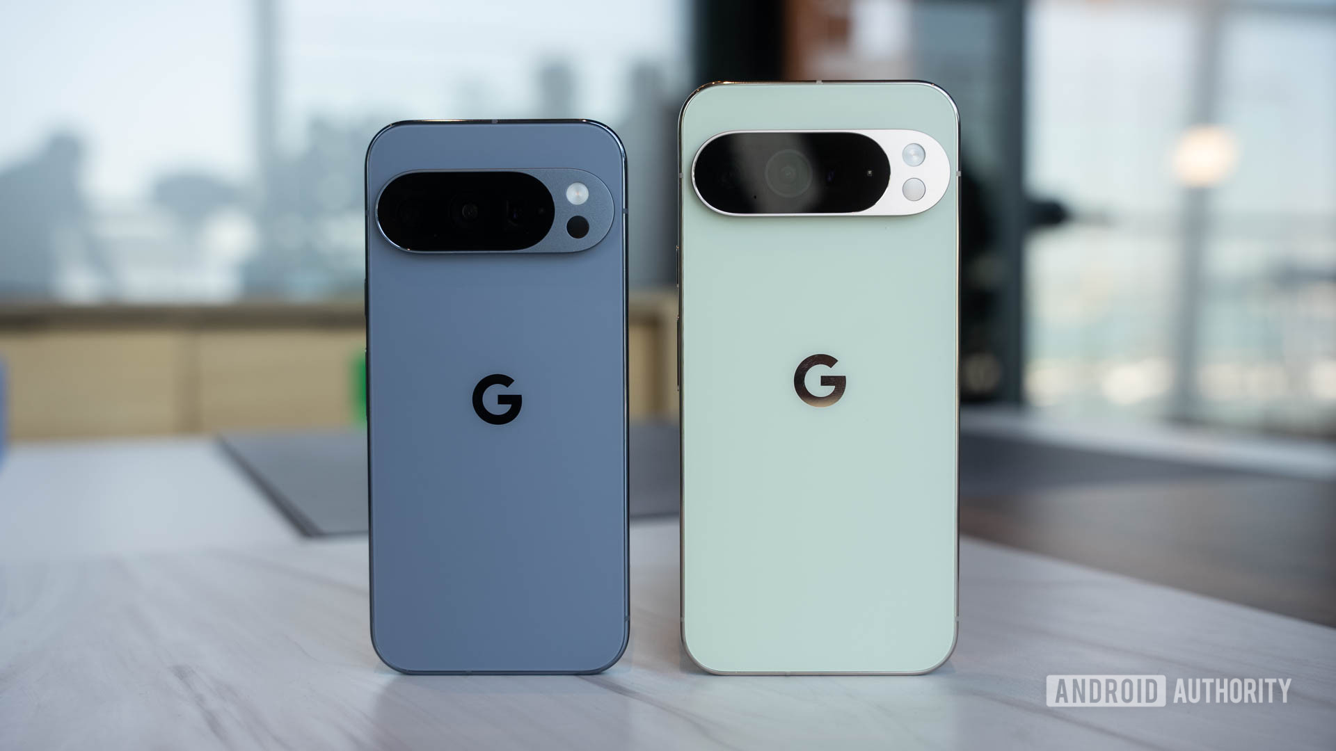 Google Pixel 10 Pro in Moonstone next to Google Pixel 10 Pro XL in Jade head on standing upright Google Pixel 10 Pro in Moonstone next to Google Pixel 10 Pro XL in Jade head on standing upright
