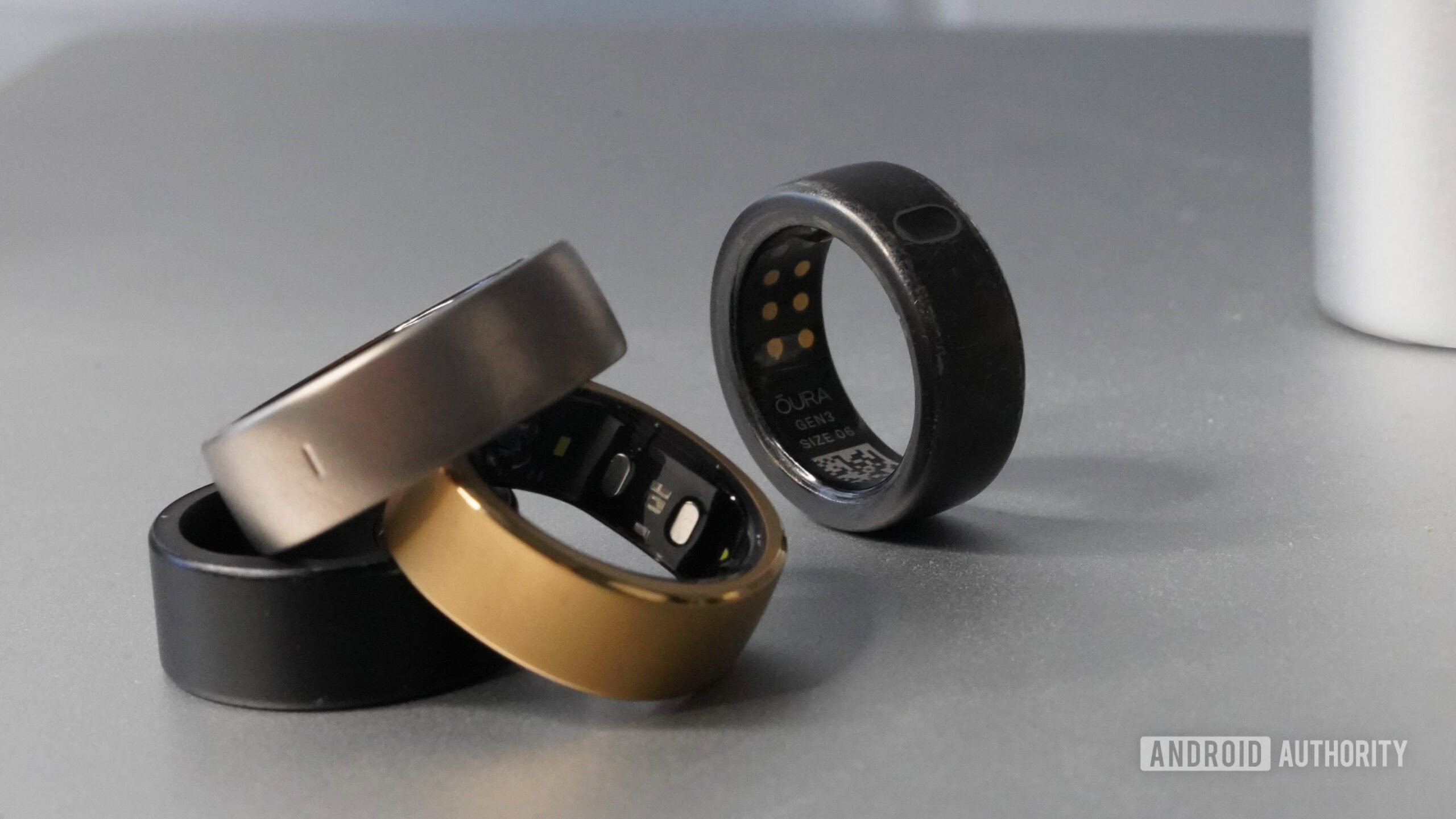 Oura Ring alternatives An Oura Ring 3 rests slightly behind a pile of alternative smart rings.